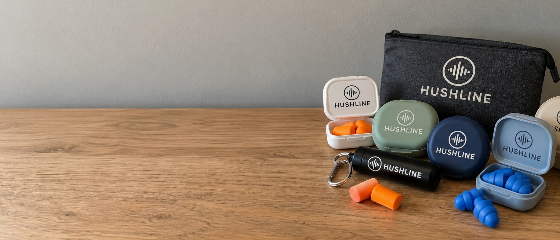 Custom ear plugs in branded cases lined up on a table